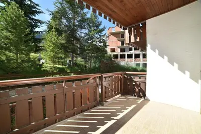 a balcony of a building with a wooden fence at Il cirmolo in Vigo di Fassa