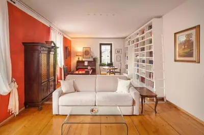 a living room with a white couch and a table at Casa Al Duomo-Nel cuore storico di Merano in Merano