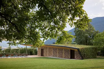 a building with a roof with a grass field at Hotel Brückenwirt in Novacella