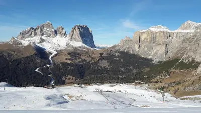 a snow covered mountain range with a ski slope at Appartamento MARMOLADA - CANAZEI in Canazei
