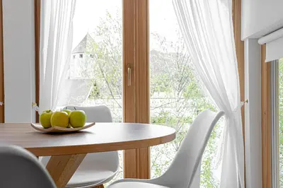 a dining room with a table and a window at Apartment Dolomites Nest in San Martino in Badia