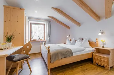 a bedroom with a wooden bed and a desk at Apartment Dolomites Nest in San Martino in Badia
