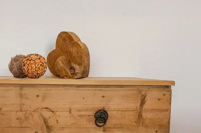 a table with two wooden objects on top of it at Apartment Dolomites Nest in San Martino in Badia