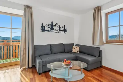 a living room with a couch and a table at Apartment Panorama Val di Non in San Felice