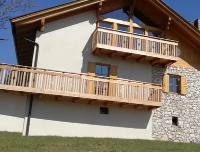 a house with a deck on the side of it at Apartment Panorama Val di Non in San Felice