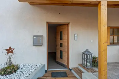 a door to a building with a star on the wall at Apartment Panorama Val di Non in San Felice