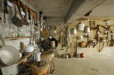 a kitchen with a bunch of utensils on the wall at Schlettererhof in Tirolo