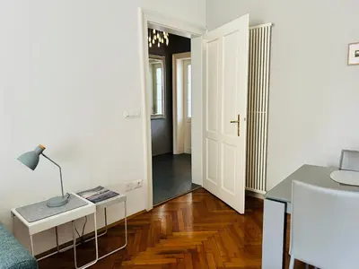 a living room with a table and a lamp at villa Mays in Merano