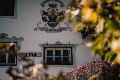 a sign on the side of a building with a window at Gasthof Residence Brugghof & Erlhof in Campo Tures
