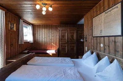 a bedroom with a bed in a wooden room at Gasthof Residence Brugghof & Erlhof in Campo Tures