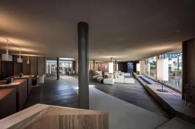 a lobby with couches and tables in a building at Adler Spa Resort Balance in Ortisei