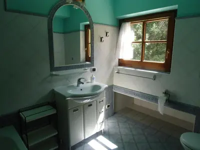a bathroom with a sink and a mirror at Rio Gambis Apartment in Cavalese