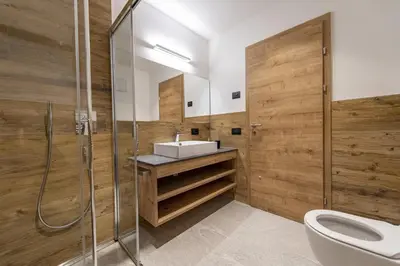 a bathroom with a sink and a shower at Luech da Perteut - Panorama and Wellness in Santa Cristina in Val Gardena
