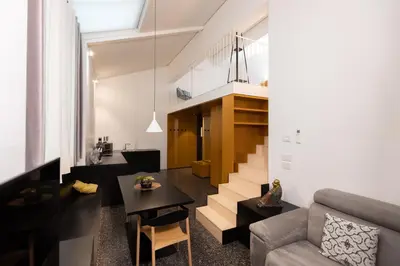 a living room with a couch and a table at Pepper Suite in Bolzano
