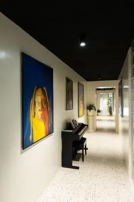 a room with a piano and a painting on the wall at Pepper Suite in Bolzano