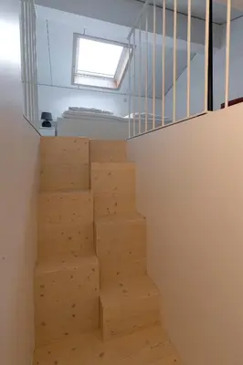 a staircase in a room with a window at Pepper Suite in Bolzano