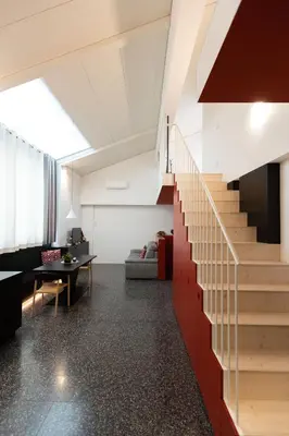 a living room with a staircase and a table at Pepper Suite in Bolzano