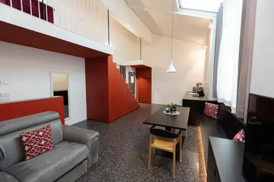 a living room with a couch and a table at Pepper Suite in Bolzano