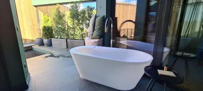 a bathroom with a bath tub and a sink at Floris Green Suites by Parc Hotel Florian in Siusi