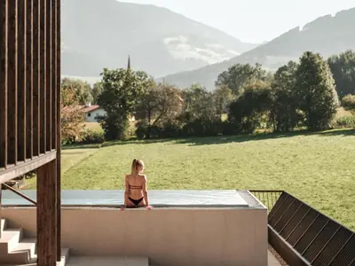a restaurant with a sign for a rooftop bar at Falkensteiner Hotel Kronplatz - The Leading Hotels of the World in Brunico
