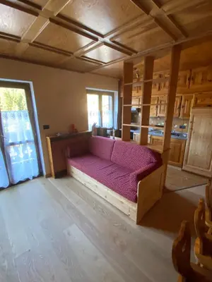 a room with a couch in the middle of a room at Casa Doleda in Alba di Canazei