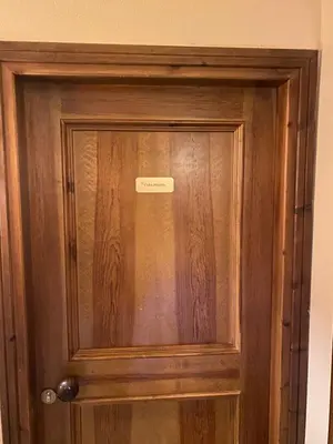 a wooden door with a sign on it at Casa Doleda in Alba di Canazei