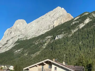 a mountain with a house in front of it at Casa Doleda in Alba di Canazei