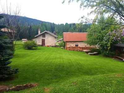 a large yard with a house and a building at Garnì Belvedere in Predazzo