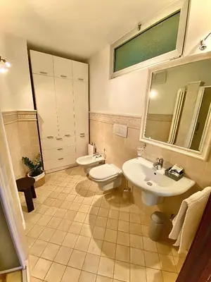 a bathroom with a sink and a toilet and a mirror at Appartamento Le Colonne - Relais Villa Quercia in Tassullo