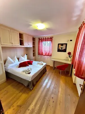 a bedroom with a large bed and a desk at Appartamento Le Colonne - Relais Villa Quercia in Tassullo