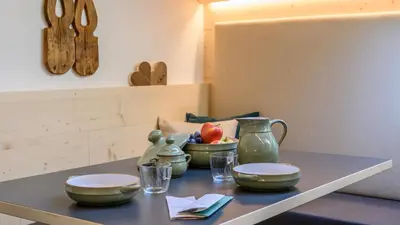 a table with bowls and plates and glasses on it at Castell Matscher in Bressanone
