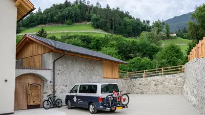 a car parked in front of a building with bikes on it at Castell Matscher in Bressanone
