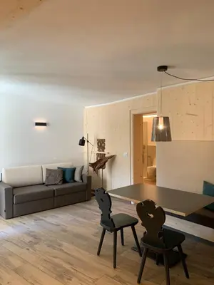 a living room with a table and two chairs at Castell Matscher in Bressanone