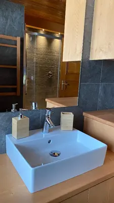 a bathroom with a white sink and a mirror at Attico Vista Tofane in Cortina dʼAmpezzo