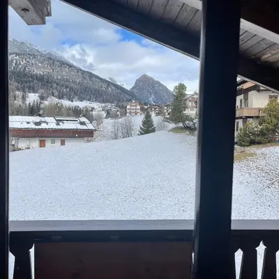 a view of a snow covered field from a window at Attico Vista Tofane in Cortina dʼAmpezzo