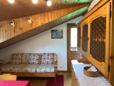 a living room with a couch in a house at Attico Vista Tofane in Cortina dʼAmpezzo
