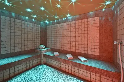 a tiled bathroom with two toilets in a room at Hotel Ranuimüllerhof in Villnoss