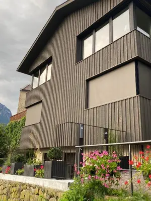 a building with flowers in front of it at Casa sciliar blu centro paese in Fiè