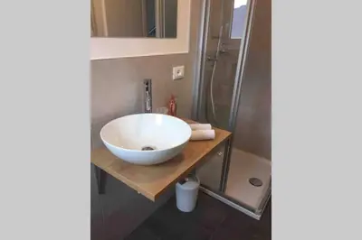 a bathroom with a bowl sink and a shower at Apartment Mathilda in Bolzano