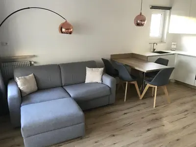 a living room with a large window and a flat screen tv at Apartment Mathilda in Bolzano