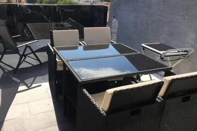 a table and chairs sitting on top of a patio at Apartment Mathilda in Bolzano