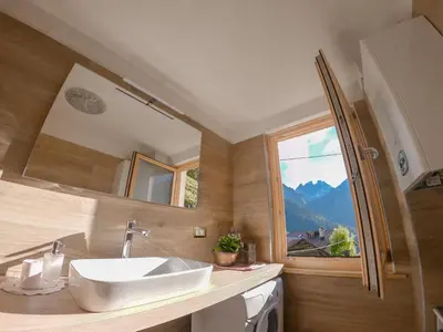 a bathroom with a sink and a mirror at Casa Soraya in Falcade
