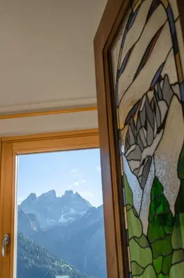 a window with a view of a mountain at Casa Soraya in Falcade