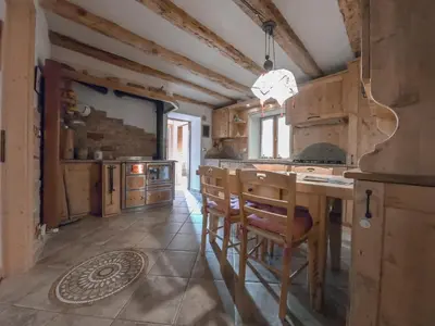 a kitchen with a table and chairs in a room at Casa Soraya in Falcade