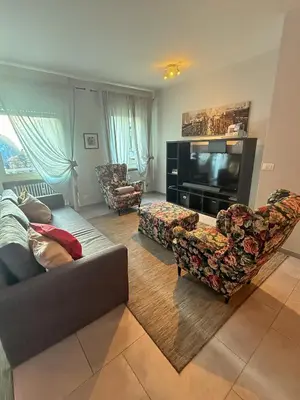 a living room with a couch and a flat screen tv at Bozen - voll ausgestattet, optimale Lage in Bolzano