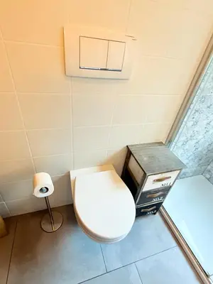 a small bathroom with a toilet and a toaster at Bozen - voll ausgestattet, optimale Lage in Bolzano