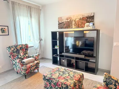 a living room with a television and two chairs at Bozen - voll ausgestattet, optimale Lage in Bolzano