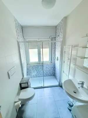 a bathroom with a shower and a toilet and a sink at Bozen - voll ausgestattet, optimale Lage in Bolzano