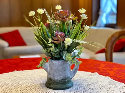 a vase filled with flowers on a table at Villa Tisot in Fiera di Primiero