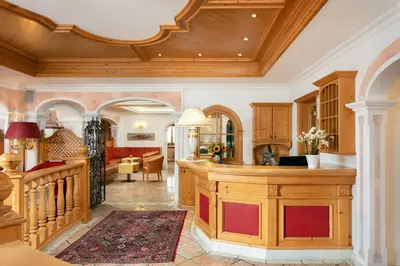 a kitchen with a wooden island in a room at Hotel Gries in Canazei